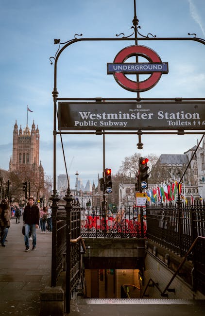 A wide view of the Palace of Westminster in London during late afternoon or early evening, with the iconic Elizabeth Tower, often called Big Ben, prominently visible on the right. The historic Gothic-